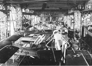 Douglas DT-2 at center with wings removed as they didn’t fold and the plane was quite large for its day and the Langley herself.